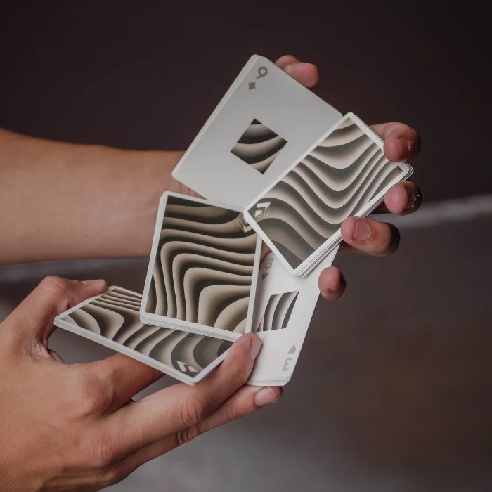 Hands fanning Spacedunes playing cards